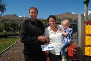 Dart River Jet Safaris Operations Manager Callan Grimmer hands over the locals day cheque to Alice and Tom Wilkins of Glenorchy Play Group.